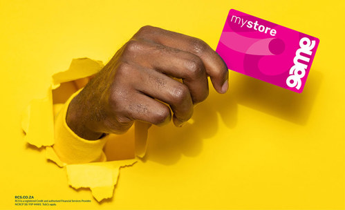 A person holding a Game mystore card with a yellow background