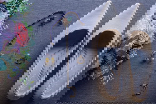 Women's Day gift ideas: white shoes, jewellery and flowers.