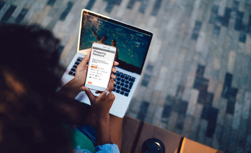 Woman with smartphone and laptop